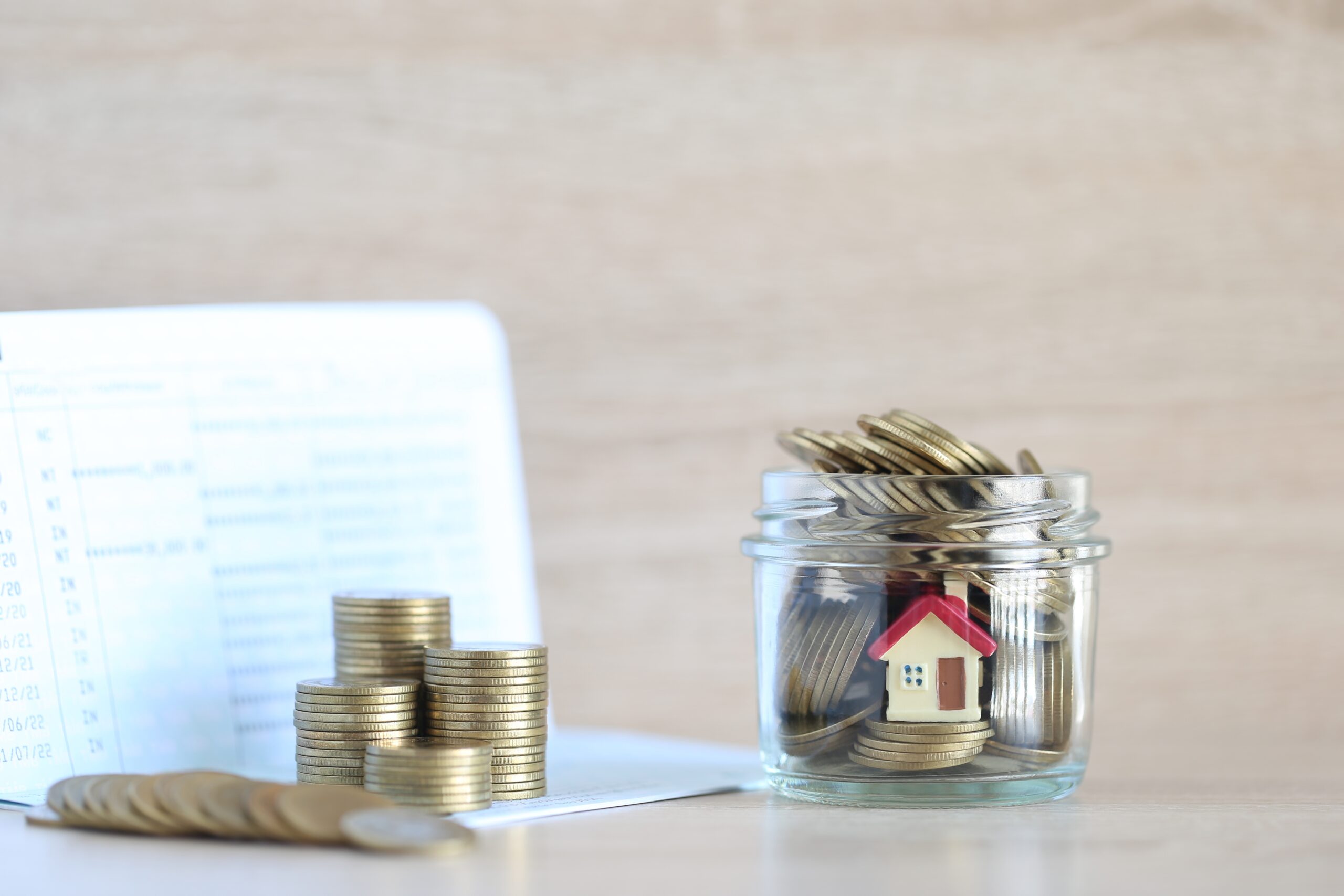 Mortgage,model,House,And,Stack,Of,Coins,Money,In,The,Glass